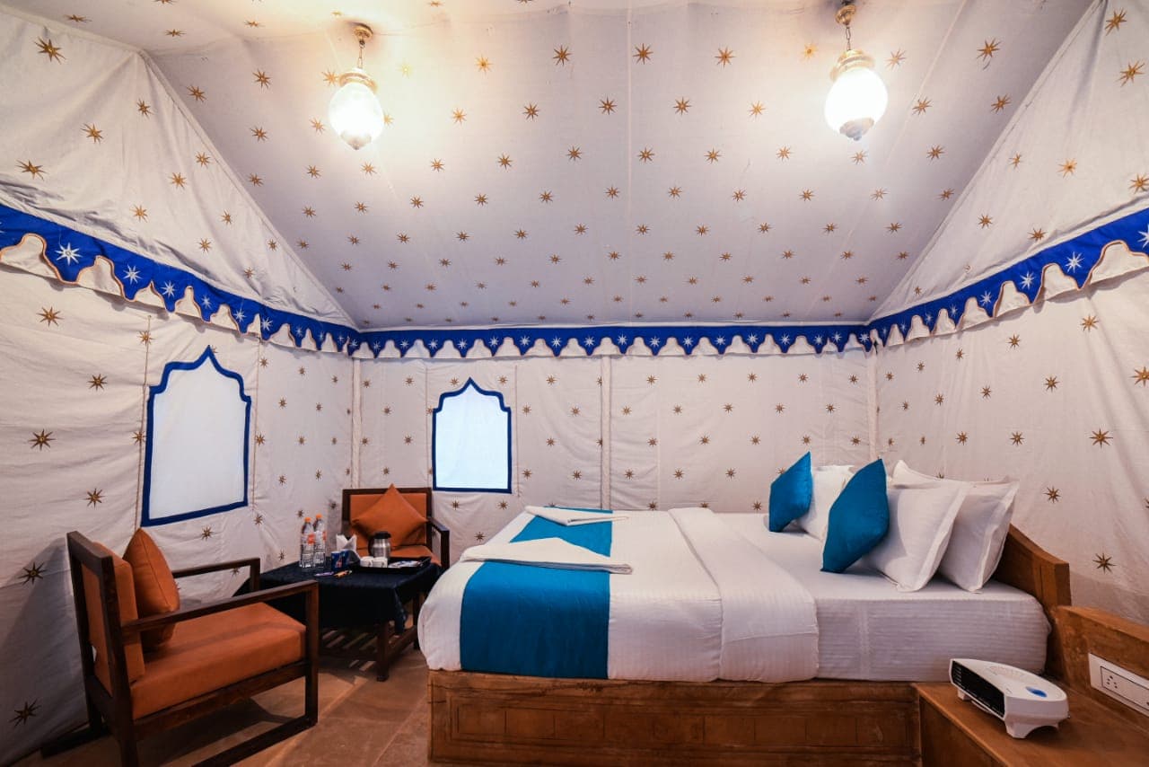 Inside a Swiss Tent — star-embroidered ceiling and double bed
